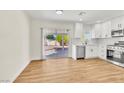 Open-concept kitchen and dining area with sliding glass doors to the backyard at 451 Concord Way, Henderson, NV 89015