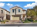 Lovely two-story home with a tile roof, two-car garage, and a paved driveway at 460 Accelerando Way, Henderson, NV 89011