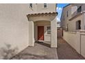 Inviting covered front porch with a red door and a stylish paved walkway leading to the entrance at 460 Accelerando Way, Henderson, NV 89011