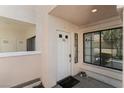 Condo entryway with a white door, unit number, and a view of the outdoor area at 4861 S Torrey Pines Dr # 106, Las Vegas, NV 89103