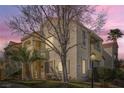 Beautiful condo features a private balcony, stucco finish, and mature palm trees at 4899 S Torrey Pines Dr # 104, Las Vegas, NV 89103
