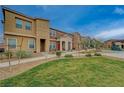 Well-maintained townhome exterior with a neat lawn and landscaping, enhancing curb appeal at 542 Foothill Cove Ln, Henderson, NV 89002