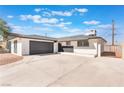A well-kept single-story home boasts a large two car garage and long concrete driveway at 6320 Hobart Ave, Las Vegas, NV 89107