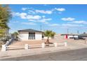 Single story home with gravel yard, palm tree, and picket fence at 6320 Hobart Ave, Las Vegas, NV 89107