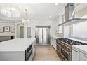 Gourmet kitchen features an oversized island and professional-grade stainless steel appliances with bright natural light at 6335 Mount Eden Ave, Las Vegas, NV 89139