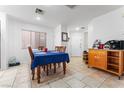 Bright dining area featuring neutral tile floors and a charming dining table at 6527 Belgrave Hall Ln, Las Vegas, NV 89122