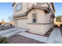 Side view of a two-story home featuring a well-manicured rock garden landscape at 6527 Belgrave Hall Ln, Las Vegas, NV 89122