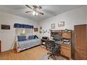 Comfortable bedroom with bright windows, a ceiling fan, and a convenient workspace area at 6705 Squaw Mountain Dr # 102, Las Vegas, NV 89130