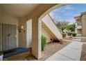 Inviting condo entrance with a secured gate, small green landscaping, and a welcoming walkway to the unit at 6705 Squaw Mountain Dr # 102, Las Vegas, NV 89130