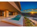 Modern home showcasing an infinity pool and spa with breathtaking sunset views at 677 Overlook Rim Dr, Henderson, NV 89012