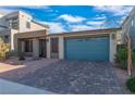 Charming home featuring a brick driveway, two-car garage, and low maintenance desert landscaping at 7177 W Camero Ave, Las Vegas, NV 89113