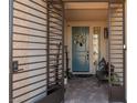 Front entryway featuring custom iron security gate, brick floor, and updated, modern door at 7177 W Camero Ave, Las Vegas, NV 89113