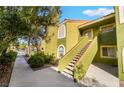 Condo exterior with a staircase leading to the upper-level units and landscaped surroundings at 7950 W Flamingo Rd # 1037, Las Vegas, NV 89147