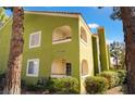 Condo exterior with private balconies overlooking lush landscaping and mature trees at 7950 W Flamingo Rd # 1037, Las Vegas, NV 89147