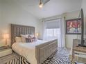 Comfortable bedroom features a tufted headboard, decorative pillows, and zebra print rug at 817 Peachy Canyon Cir # 204, Las Vegas, NV 89144
