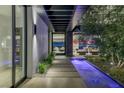 Stunning modern entryway featuring a water feature and city views beyond the open floor plan at 9 Boulderback Dr, Henderson, NV 89012