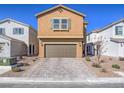 Two-story home featuring a brown stucco exterior, a two-car garage, and desert landscaping at 10279 Fragrant Apple Ct, Las Vegas, NV 89141