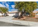 Lovely one-story home offers a roomy three-car garage complemented by a beautifully landscaped front yard at 1114 Cedar Dove Rd, North Las Vegas, NV 89081