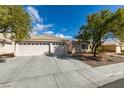 A welcoming single-story house boasts a generous three-car garage and a neatly kept front yard at 1114 Cedar Dove Rd, North Las Vegas, NV 89081