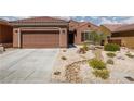 Beautiful single story home featuring low maintenance desert landscaping and a two-car garage at 1407 Wheelwright Ct, Mesquite, NV 89034