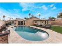 Inviting backyard pool with lounge chairs, lush green grass, and privacy fencing for relaxation and entertainment at 1462 Rawhide St, Las Vegas, NV 89119