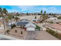 Charming single story home with solar panels, a front yard, driveway and palm trees at 1462 Rawhide St, Las Vegas, NV 89119