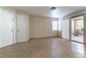 Spacious living room with tile floors, a sliding glass door to balcony and neutral walls at 1560 Jamielinn Ln # 101, Las Vegas, NV 89110