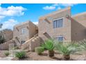 Condo building with desert landscaping, blue sky, and individual unit stairways at 1909 Mountain Hills Ct # 103, Las Vegas, NV 89128