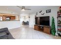 Open living room with tile floors, ceiling fan, and views of the kitchen and dining area at 2300 E Silverado Ranch Blvd # 1037, Las Vegas, NV 89183