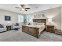 Comfortable bedroom featuring a king-size bed, ceiling fan, and natural light from the windows at 2833 Athena Hill Ct, Henderson, NV 89052