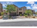 Two-story home with a brick driveway, desert landscaping and a small front balcony at 2833 Athena Hill Ct, Henderson, NV 89052
