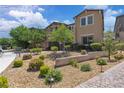 Well maintained front yard with decorative rock and appealing landscaping, complemented by an attractive home exterior at 2833 Athena Hill Ct, Henderson, NV 89052