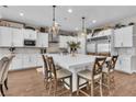 Bright kitchen features a large island with pendant lights and stainless steel appliances at 2833 Athena Hill Ct, Henderson, NV 89052