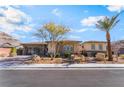 Beautiful single-story home featuring drought tolerant landscaping, and an attached garage at 3120 Greenscape Ln, Las Vegas, NV 89138