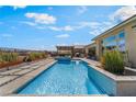 Inviting backyard pool area with a modern pool, spa, and lush landscaping at 3120 Greenscape Ln, Las Vegas, NV 89138