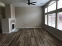 Bright living room boasting wood-look floors, fireplace, ceiling fan, and large windows at 331 Mount Hope St, Henderson, NV 89014