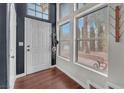 Bright entryway with hardwood floors, a stylish chandelier, and large windows with natural light at 3536 Golden Pedal St, Las Vegas, NV 89129