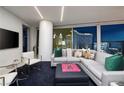 Cozy living room area with large sectional couch, city views, and plush carpeting at 3726 S Las Vegas Blvd # 1107, Las Vegas, NV 89158