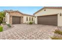 Paver driveway leading to two garages, complemented by desert landscaping at 4078 San Franchesca Ct, Las Vegas, NV 89141