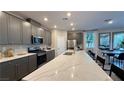Modern kitchen with a large island, stainless steel appliances, and sleek gray cabinetry at 4181 Nopal Serrano Ave, Las Vegas, NV 89141