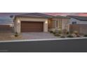 Charming single-story home featuring desert landscaping, a brick driveway and a two car garage at 4315 E Cactus Canyon Dr, Pahrump, NV 89061