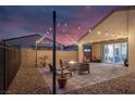 Beautiful outdoor patio with modern furniture and string lights at dusk at 4315 E Cactus Canyon Dr, Pahrump, NV 89061