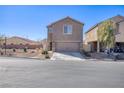 Two-story stucco home with an attached two-car garage and desert landscaping at 5285 Bombazine St, Las Vegas, NV 89122