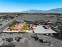 Expansive property featuring a home, pool, mature trees, and a large, versatile lot with red-roofed outbuildings at 5340 N Campbell Rd, Las Vegas, NV 89149
