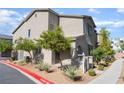 Side view of a two-story home with low maintenance landscaping and a clean aesthetic at 760 Crisp Morning Ct, North Las Vegas, NV 89086