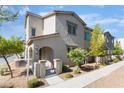 Attractive townhome featuring neutral stucco, covered entryway and low water landscaping at 760 Crisp Morning Ct, North Las Vegas, NV 89086