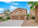 Inviting two-story home with a neatly kept yard, mature trees, and an attached three-car garage at 8421 Vivid Violet Ave, Las Vegas, NV 89143