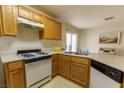Functional kitchen with wood cabinets, and standard appliances at 9935 Swimming Hole St, Las Vegas, NV 89183