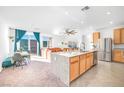 Bright, open kitchen featuring granite countertops, stainless steel appliances, and a large island at 10009 Locking Biner Ave, Las Vegas, NV 89166