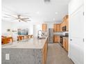 Bright open kitchen with granite countertops, stainless steel appliances, and a large central island at 10009 Locking Biner Ave, Las Vegas, NV 89166
